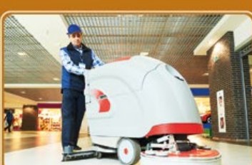 Operative using a ride-on scrubber dryer on a hard floor
