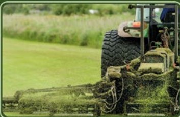 Tractor mowing a commercial lawn